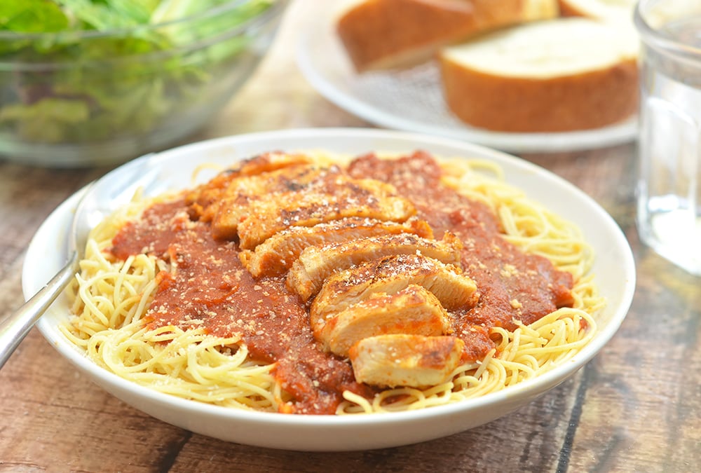 Spicy Cajun Chicken served with hearty Ragu tomato sauce and angel hair pasta