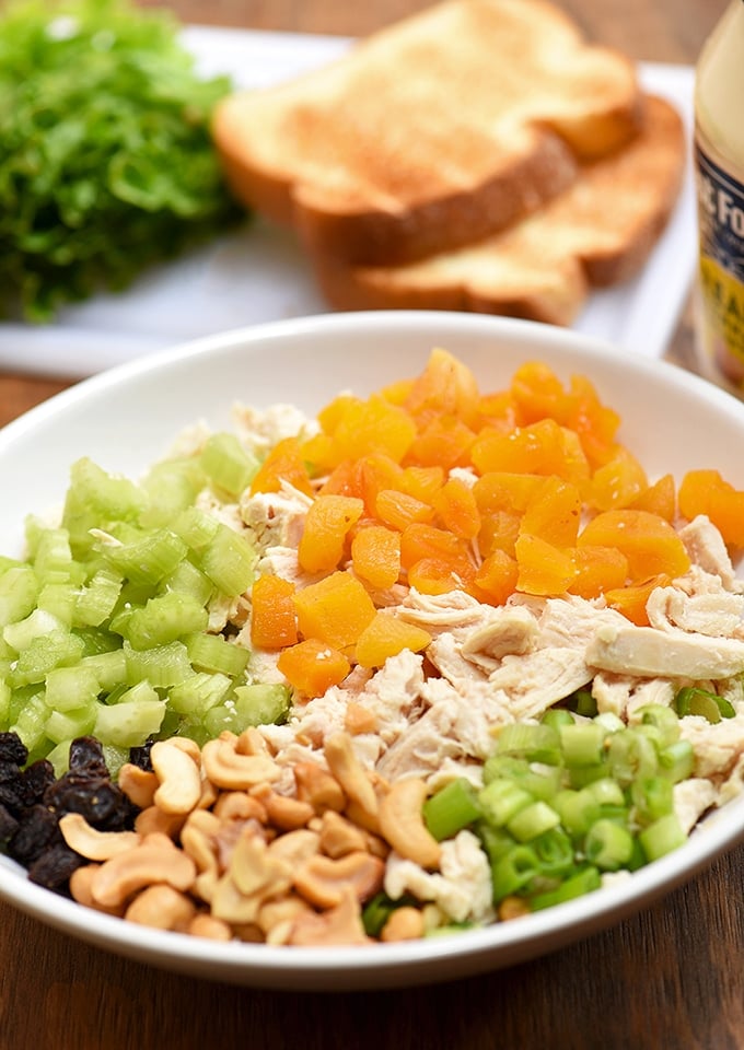 Shredded chicken, dried apricots, cashews, celery, raisins, and green onions are the perfect combination for this chicken salad.