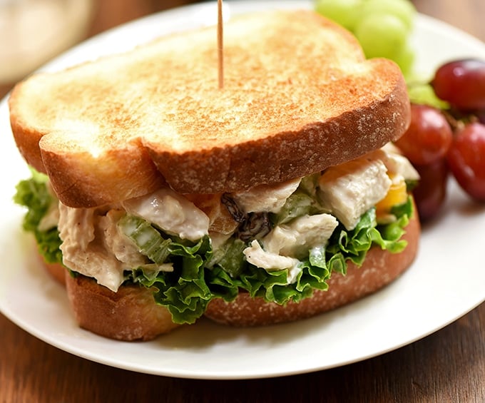 Apricot and cashew chicken salad sandwich is perfect when served on toasted bread with green leaf lettuce.