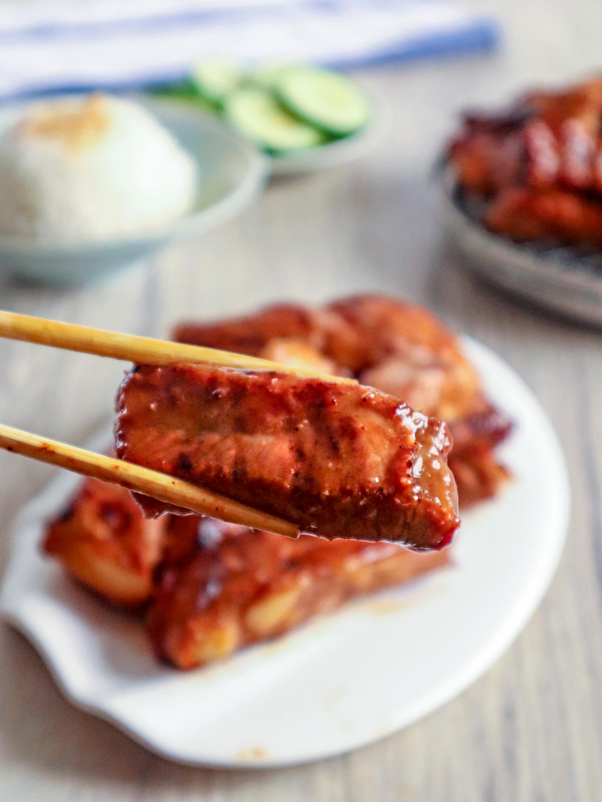 eating Asian pork ribs with chopsticks