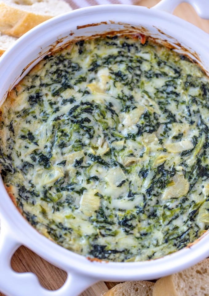 Spinach Artichoke dip in a white baking dish