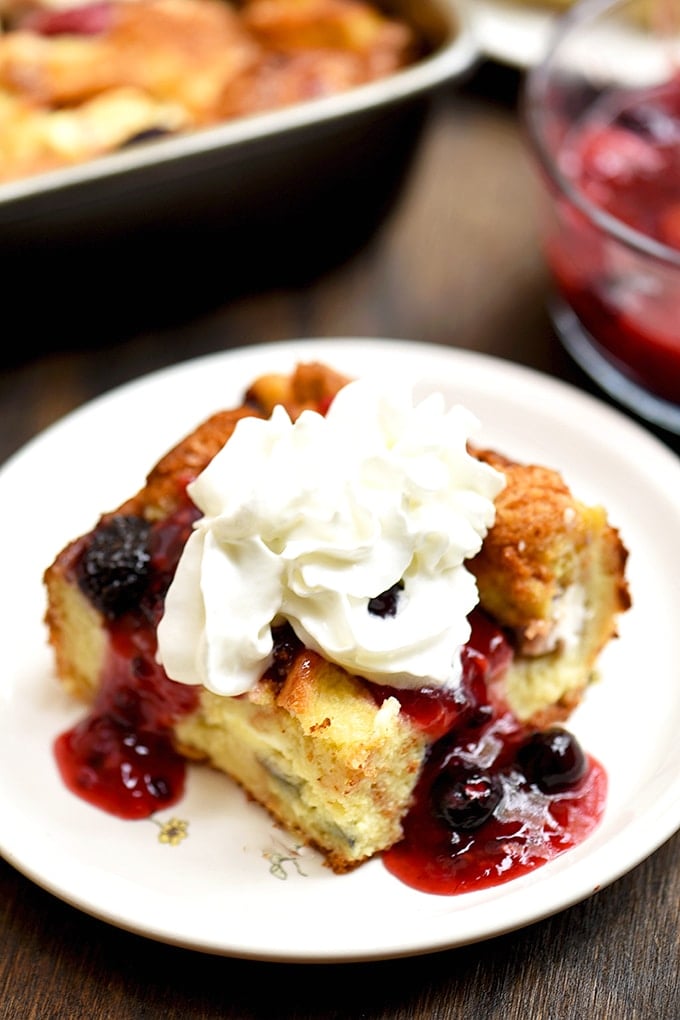 French Toast bake with cream cheese, blueberries, strawberries, raspberries, and blackberries. Topped with fruit sauce and whipped topping!