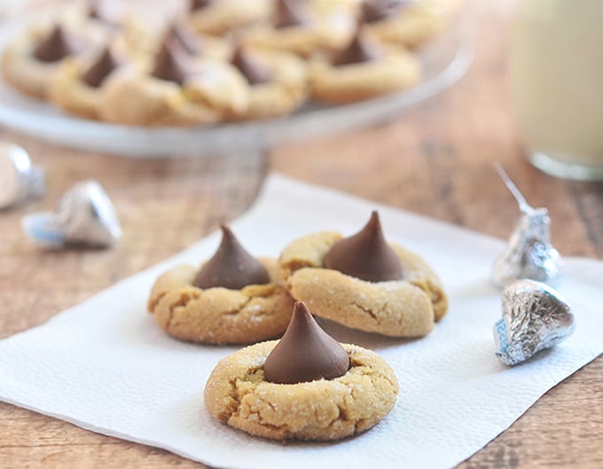 Peanut Butter Blossoms are made from chewy peanut butter cookies and sweet chocolate kiss centers. These are as fun to make as they are to eat!