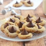 Peanut Butter Blossoms made of chewy peanut butter cookies and sweet chocolate kiss centers. These are as fun to make as they are to eat!