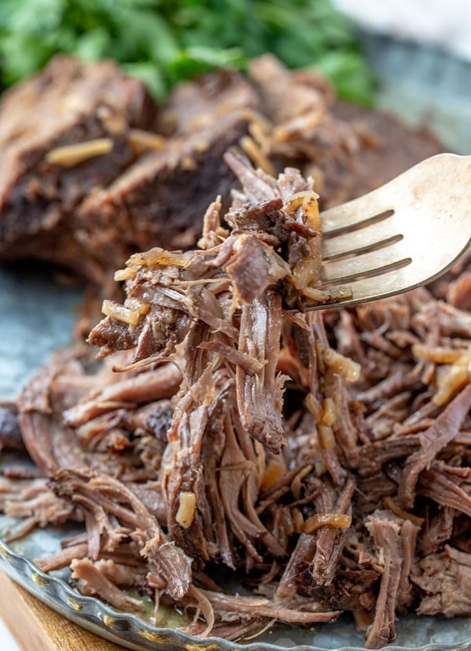 serving shredded beef roast with a fork