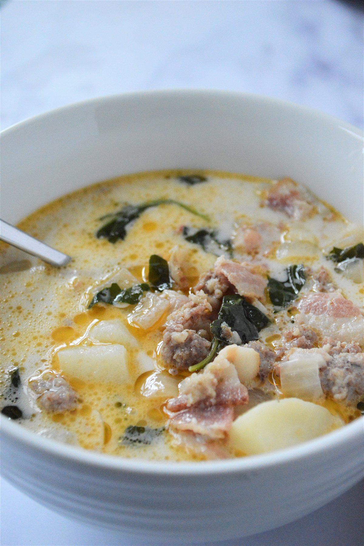 eating tuscan soup with a spoon from a bowl