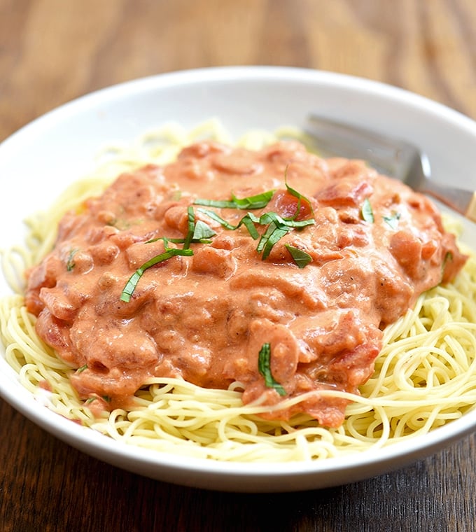 Angel Hair Pasta with Tomato Cream Sauce on a white plate