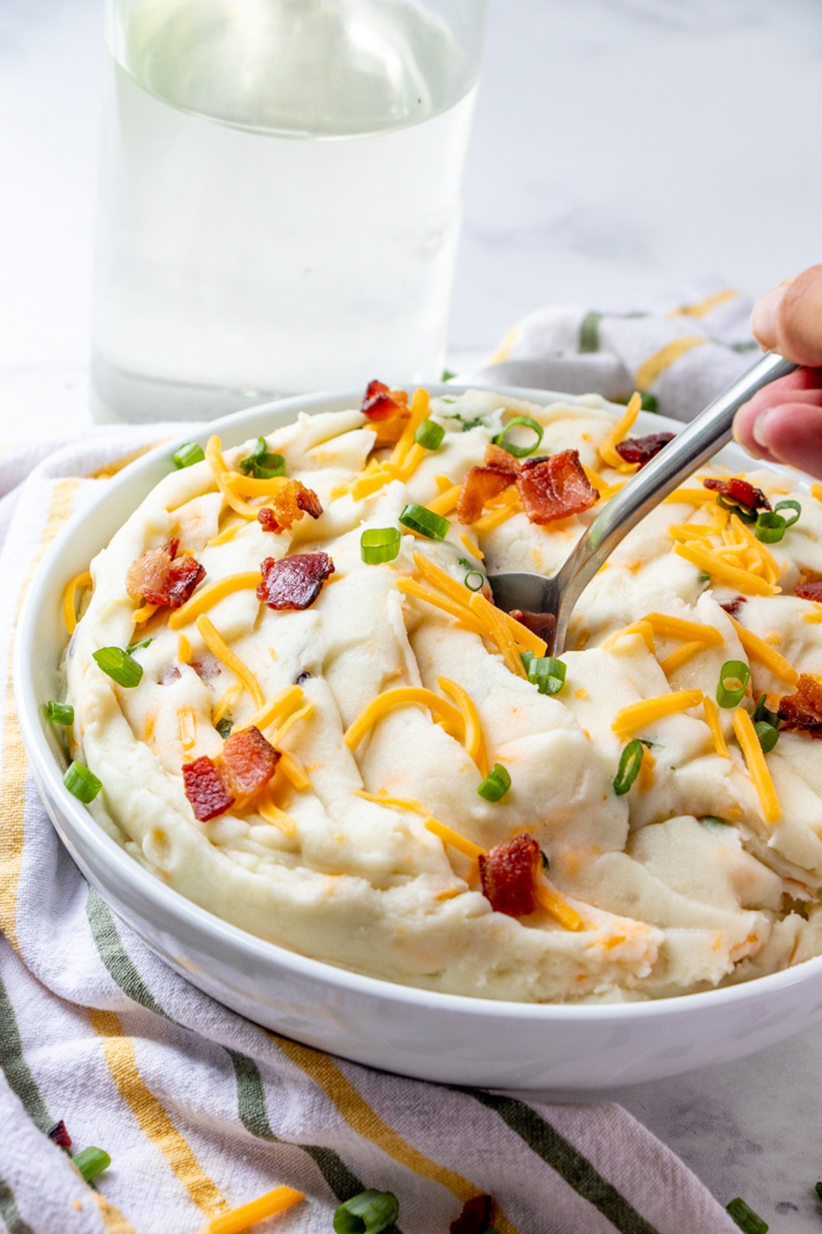 eating loaded mashed potatoes in a bowl