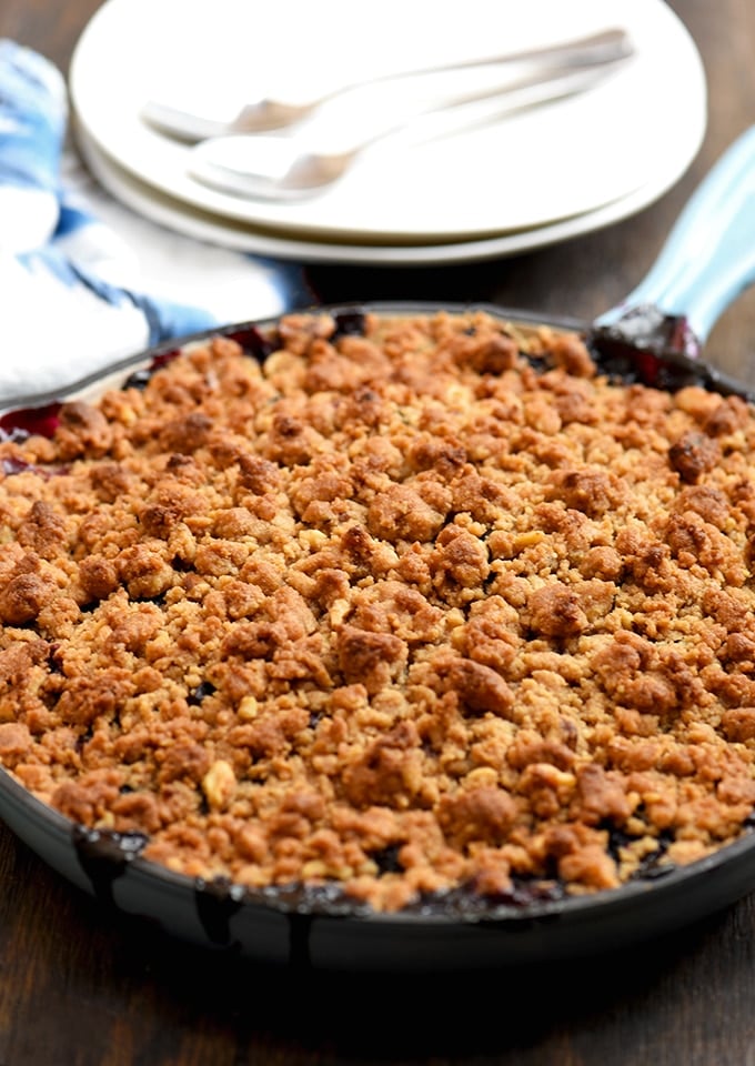 Berry Crisp with assorted berries and buttery crumble on top baked in a blue skillet