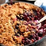Mixed Berry Crumble baked in a blue enameled cast iron skillet