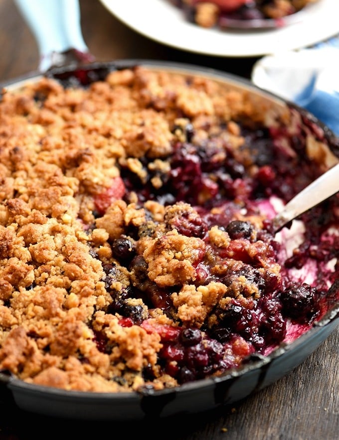 Mixed Berry Crumble baked in a blue enameled cast iron skillet