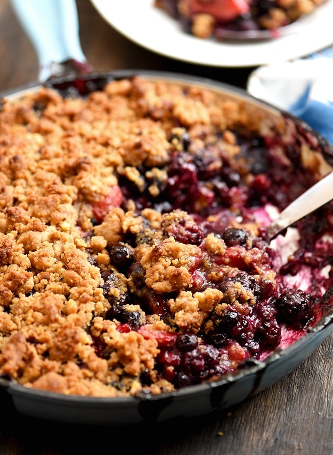 Mixed Berry Crumble baked in a blue enameled cast iron skillet