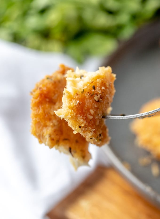 serving parmesan crusted tilapia with a fork