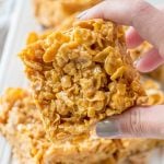 hand holding peanut caramel frosted flakes bars