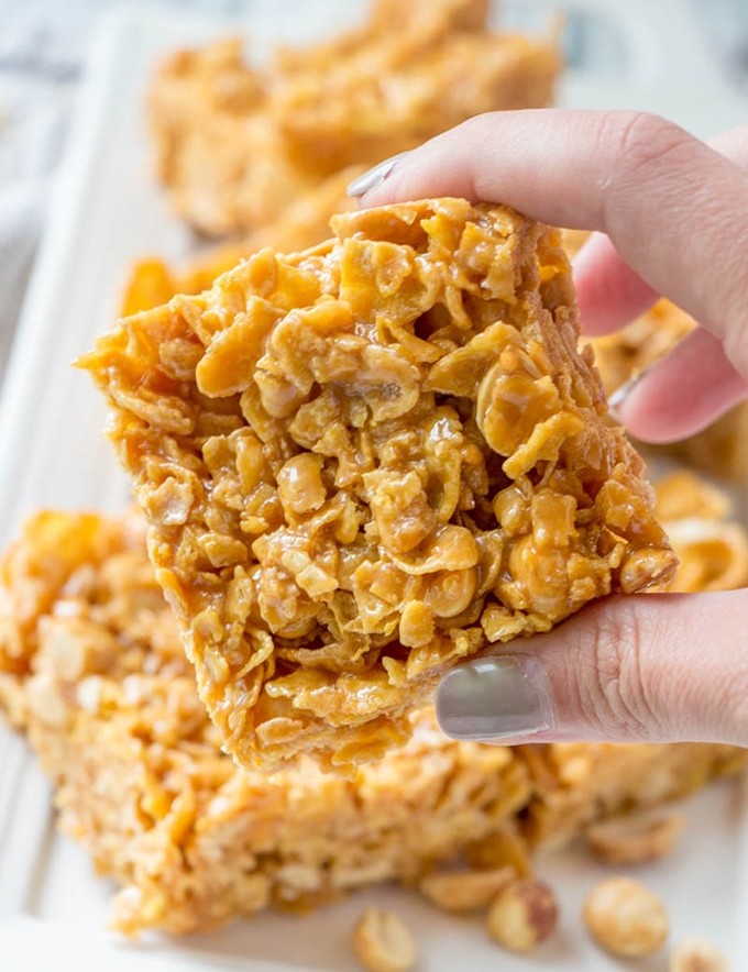hand holding peanut caramel frosted flakes bars