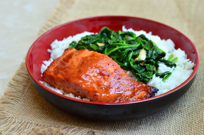 Sweet Chili Salmon with Garlic Spinach topped with sweet chili glaze and served over a bed of garlicky spinach. It makes a flavorful dinner meal and it's ready in minutes!