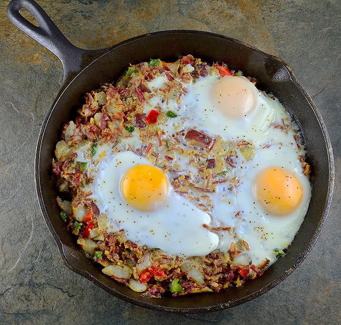 Corned Beef Hash cooked in a cast iron skillet and topped with egg. Hearty and delicious, it makes for a great breakfast and light lunch or dinner.