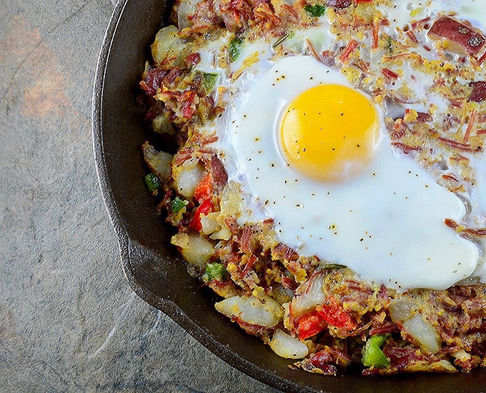 Corned Beef Hash is a delicious breakfast you can whip up from your leftover St. Patrick's feast! A hearty combination of corned beef, potatoes, bell peppers, and runny eggs, it makes a great dinner, too!