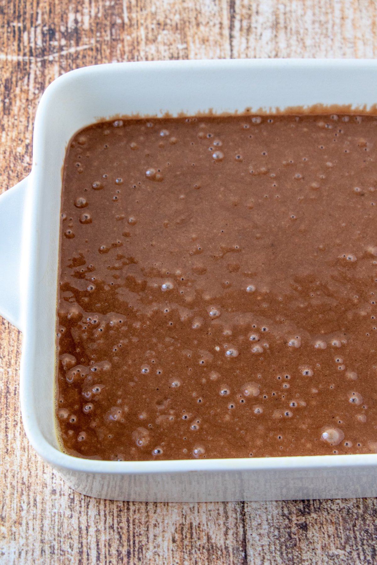 wacky cake batter in a white baking dish