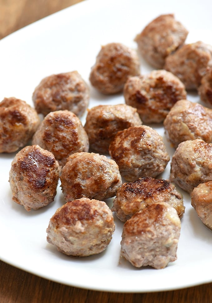 pan-fried meatballs on a white platter