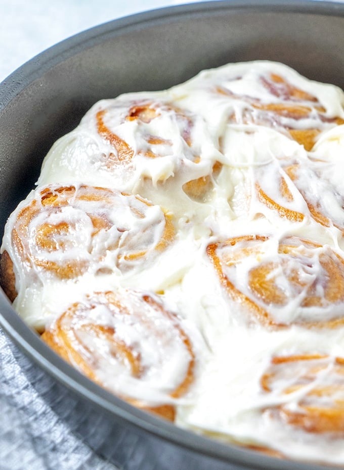 Raspberry Cheese Danish with cream cheese frosting in a round baking pan