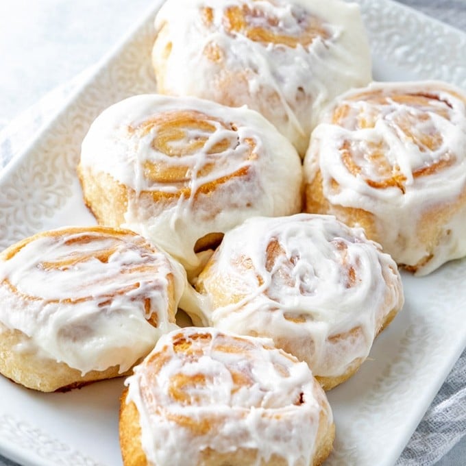 Raspberry Cheese Danish with cream cheese frosting on a white serving platter