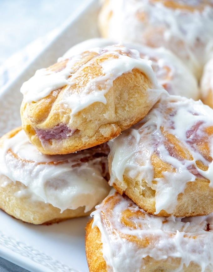 Crescent Roll Danish with raspberry cheese filling and cream cheese frosting on a white platter