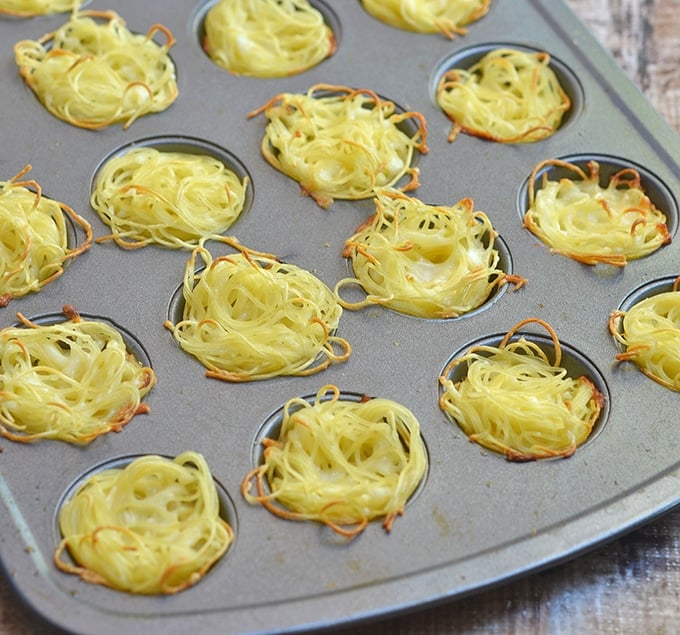 Mini spaghetti nests are baked in a mini muffin tin for cute and delicious appetizers.