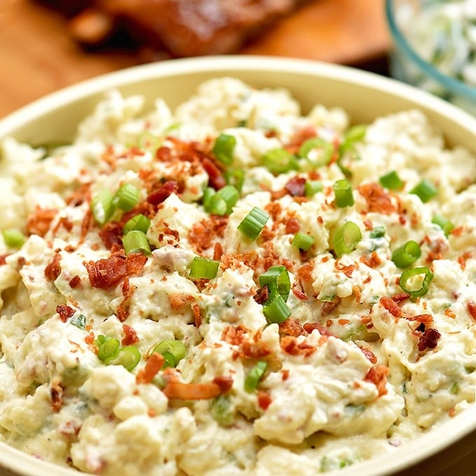 Loaded Potato Salad with bacon crumbles, chopped eggs, crisp celery and green onions