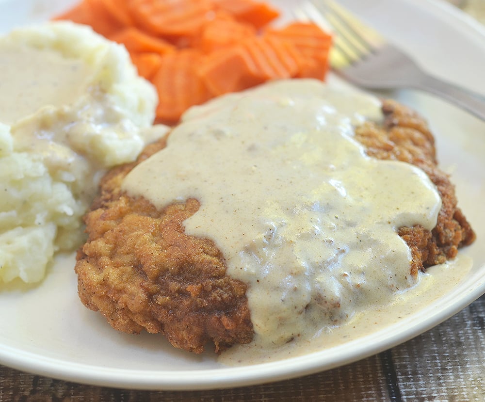 Country Fried Steak with Creamy Gravy made crispy, super tender and tasty using a buttermilk marinade. Hearty and delicious with a flavorful milk gravy, it is the ultimate comfort food.