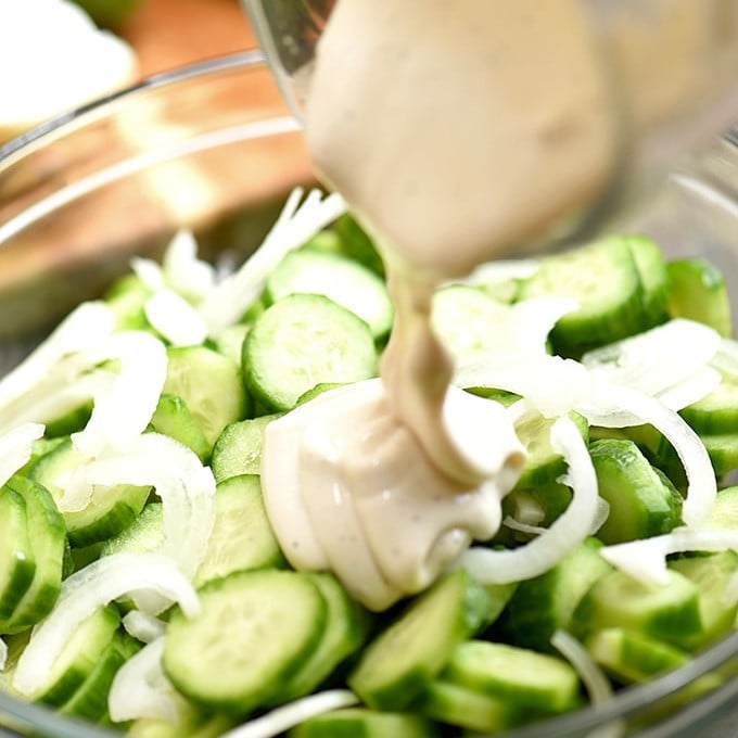 sliced cucumbers and sweet onions drizzled with mayo dressing