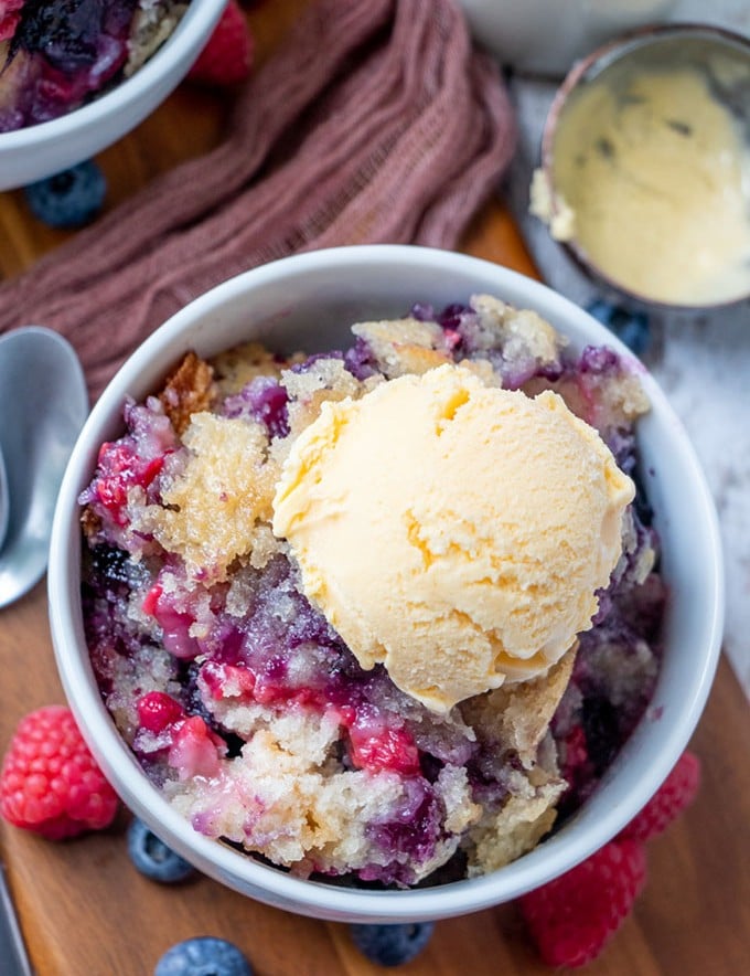 Mixed Berry Cobbler in a bowl with vanilla ice cream
