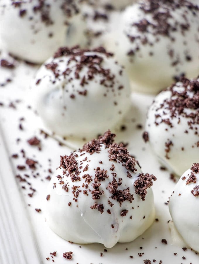 Oreo Cookie Balls with white chocolate coating on a white serving platter