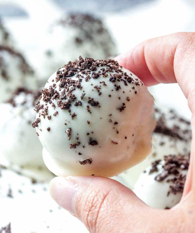 holding a white chocolate Oreo Truffles