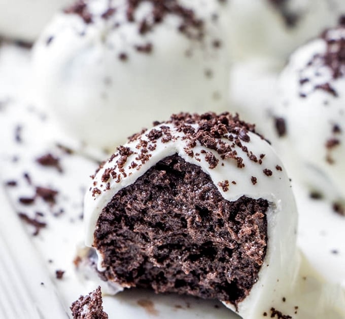 Oreo Truffle Balls with white chocolate coating and cookie crumbs on a serving platter