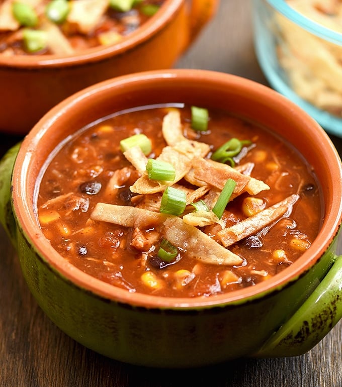 Easy chicken tortilla soup recipe loaded with all the good stuff. With moist chicken, black beans, corn, and crisp tortilla strips, it's hearty and delicious!