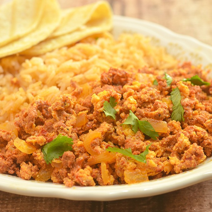 Chorizo con Huevos made with crumbled Mexican sausage and scrambled eggs. Hearty and delicious, it's perfect paired with Spanish rice and beans for breakfast as well as fillings for tacos, enchiladas or burritos.