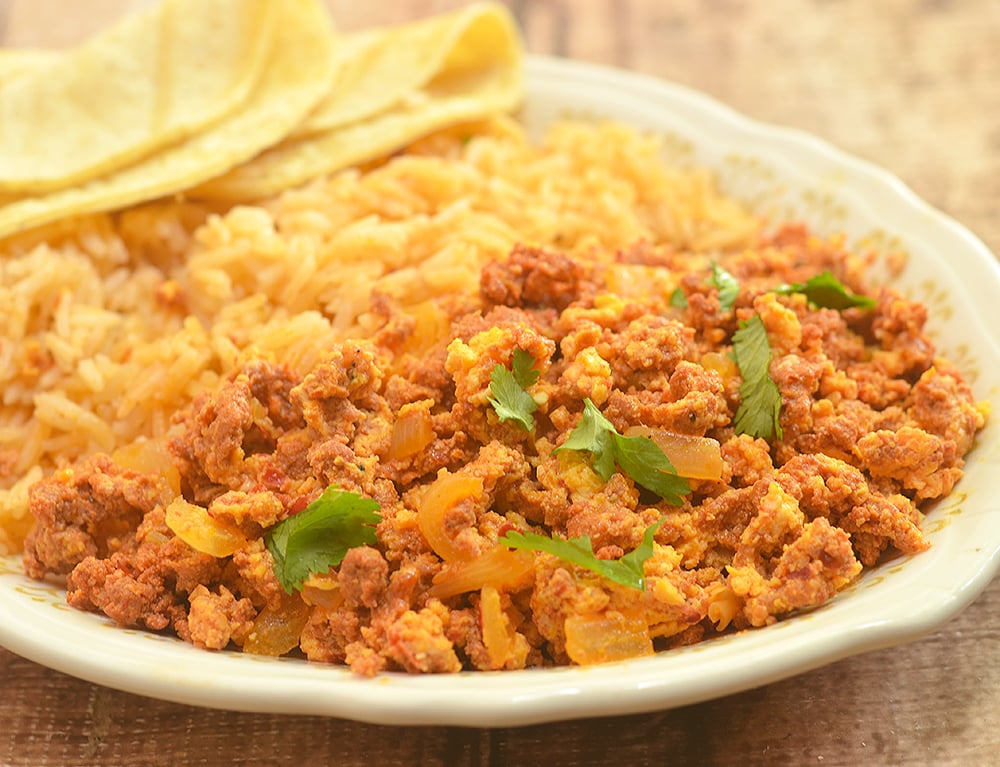 Chorizo con Huevos made with crumbled Mexican sausage and scrambled eggs. Hearty and delicious, it's perfect paired with Spanish rice and beans for breakfast as well as fillings for tacos, enchiladas or burritos.