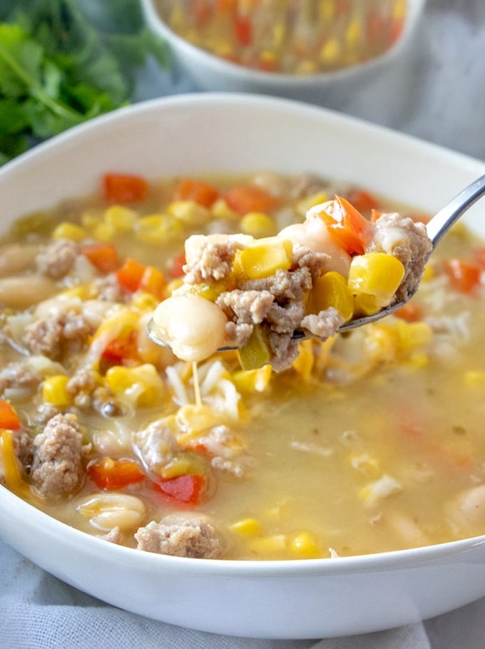 eating turkey chili from a bowl with a spoon