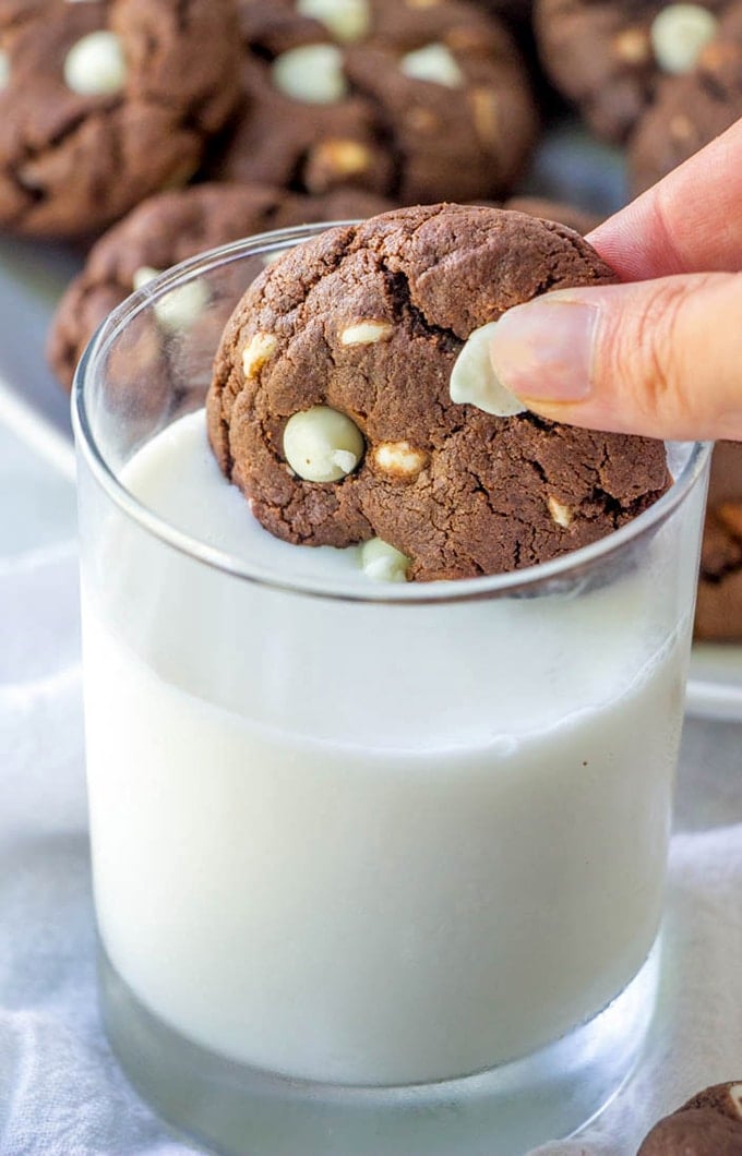 dunking White Chocolate Chip Cookies in a glass of milk
