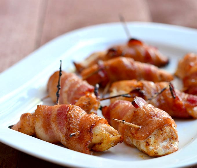 Sweet Chili Bacon-Wrapped Chicken Tenders coated in brown sugar and chili powder and then baked until crisp and delicious! Perfect as game day appetizers or as an easy weeknight dinner.