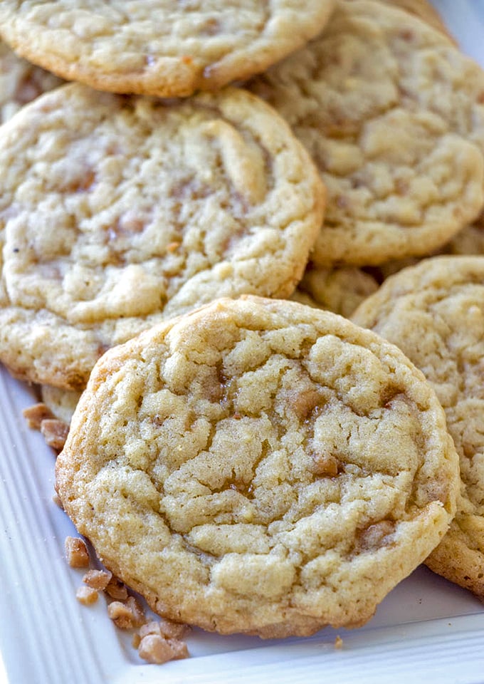 These heath toffee cookies look irresistible on this white plate, ready for serving. 