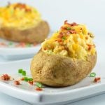 Loaded Twice-Baked Potatoes are a delicious side dish or satisfying light meal. Loaded with bacon, cheddar cheese, and green onions, they're hearty, delicious and guaranteed to a be a family favorite!