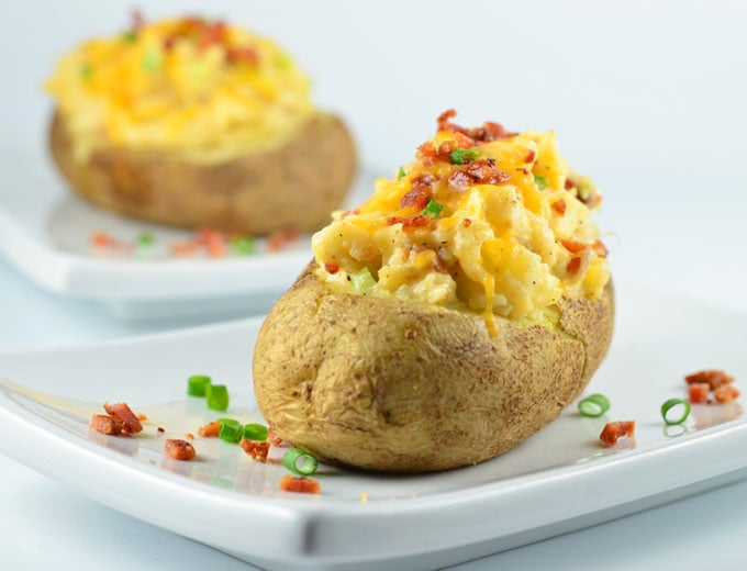 Loaded Twice-Baked Potatoes are a delicious side dish or satisfying light meal. Loaded with bacon, cheddar cheese, and green onions, they're hearty, delicious and guaranteed to a be a family favorite!