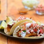 Blackened tilapia fish tacos seasoned with an amazing spice rub and topped with shredded cabbage, fresh pico de gallo, and crema Mexicana. They're a fresh, healthy, and easy meal for busy weeknights!