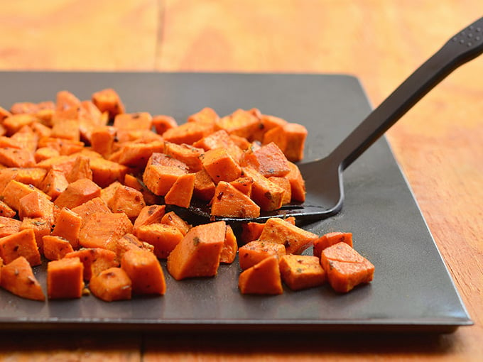 Roasted spiced sweet potatoes seasoned with spices and roasted until golden and crisp are the perfect Fall side dish. The perfect pair for any roasted meat, they're sure to be the star of your Thanksgiving festivities!