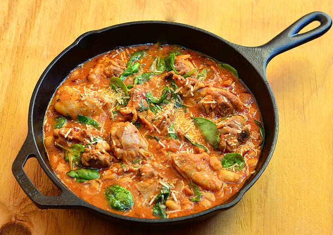 Tuscan Chicken with spinach, white beans, and an amazing tomato sauce. Hearty, delicious, and incredibly easy to make, it's a guaranteed to be a dinner favorite! 