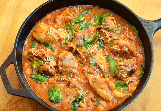 Tuscan Chicken cooked in a creamy tomato sauce with spinach and cheese