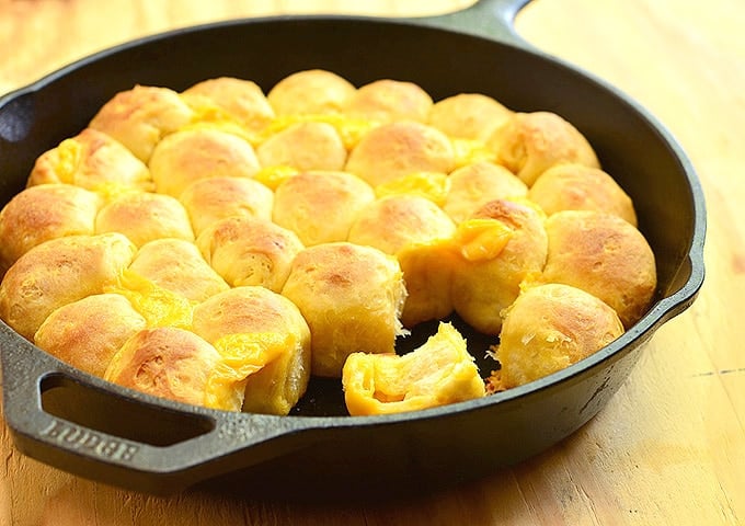 cheesy pull-apart bread rolls in a cast iron skillet