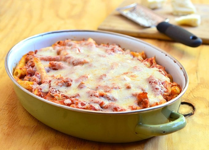 baked ziti with ricotta and Italian sausage in a casserole dish